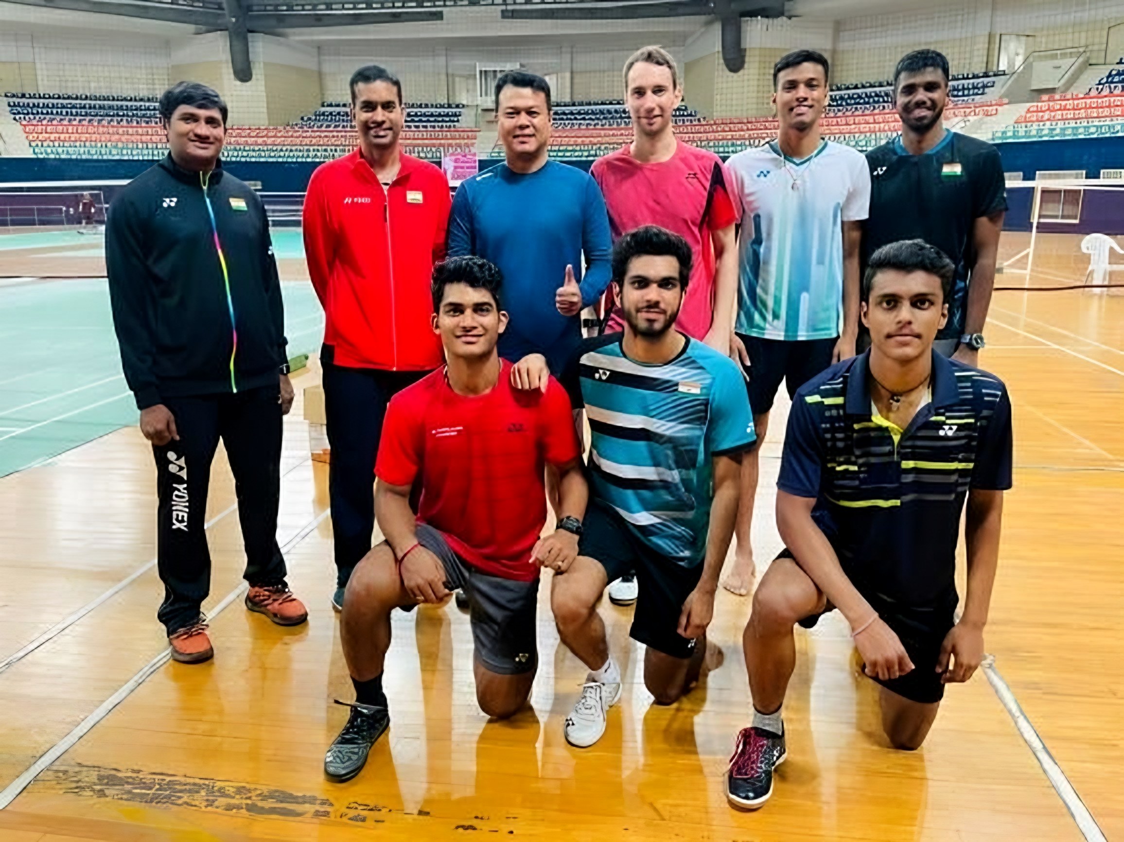 Lomada Raju with a badminton squad after a training session